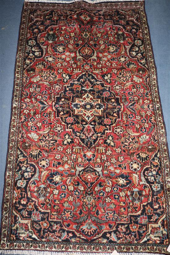 A Kashan red ground rug, 5ft 3in by 2ft 1in.